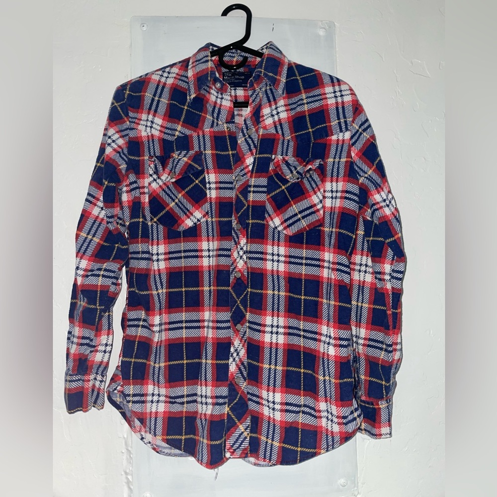 The men’s shop. Red white and blue plaid. Pearl snap long sleeve flannel